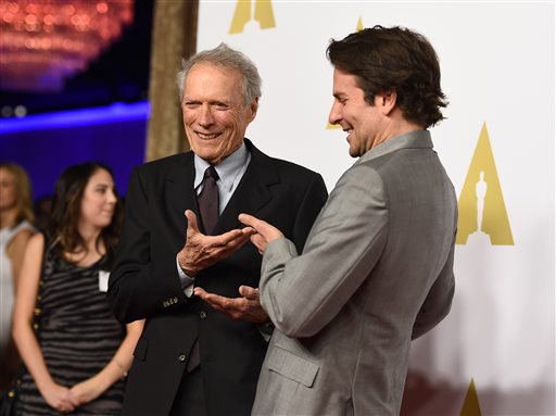 American Sniper's director Clint Eastwood and leading actor Bradley Cooper pose at the Oscar nomination ceremony.