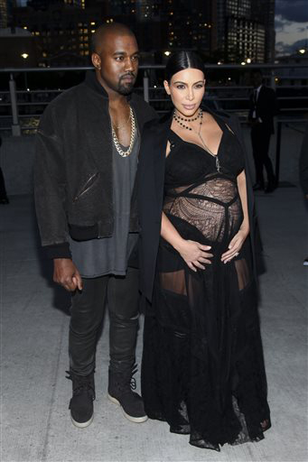 Kanye West and Kim Kardashian pose before attending the Givenchy show. Courtesy of Andy Kropa/AP
