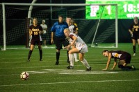 Brianna Blunck eyes the ball as an Iona defender looks on. (Andrea Garcia/The Fordham Ram). 